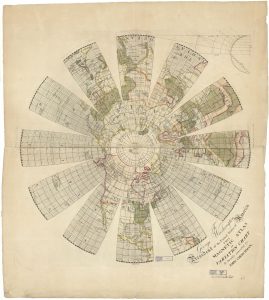 Color photograph of a printed map on paper discolored with age. The main image is a globe with longitude and latitude lines with the continents colored in and labeled. The view is from the north pole down with the pole in the center and the globe sliced into 6 longitude sections all the way around. In the bottom right corner is black ink printed text that is written in cursive and print which reads, “To George Washington President of the United States of America This Magnetic Atlas or Variation Chart is humbly inscribed by John Churchman.” With two blue stamps that read “Harvard College Library.”