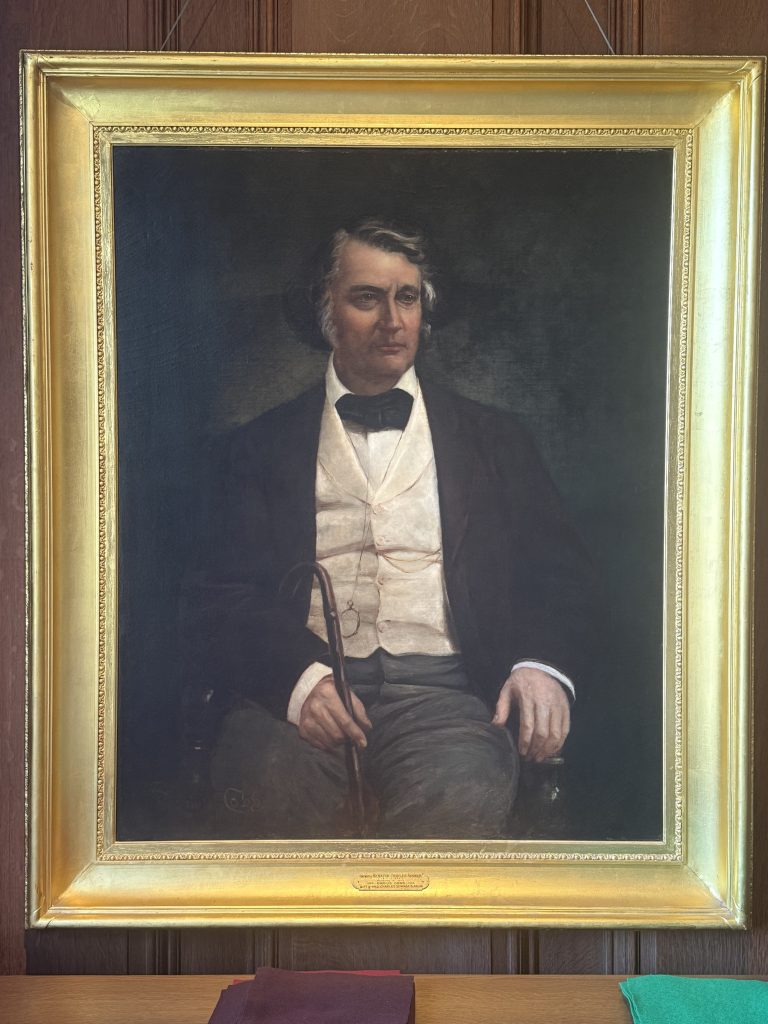 painting of man in a suit framed in a gold frame