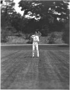 Tennis player, possibly Edward L. Hall, in motion Photograph