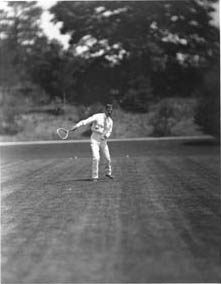 Tennis player, possibly Edward L. Hall, in motion Photograph