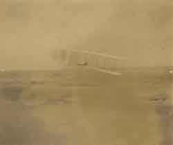 One of the Wright brothers (unidentified) flying the Wright glider, Outer Banks, North Carolina, 1903 Photograph One of the Wright brothers (unidentified) flying the Wright glider, Outer Banks, North Carolina, 1903 Photograph
