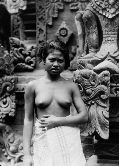 Woman standing in front of a temple, Southeast Asia Lantern slide