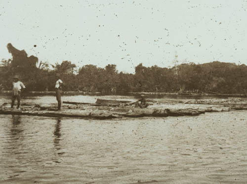 Raft of logs being towed from river Lantern slide