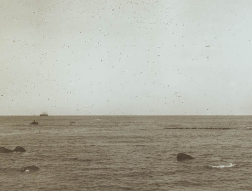 Raft from river being taken to beach Lantern slide