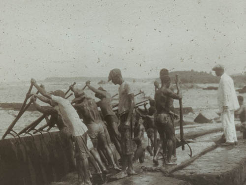 Rolling logs into water Lantern slide