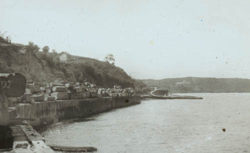 Logs on Secondee sea-wall Lantern slide