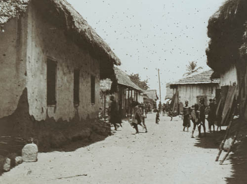 Passing through a native village Lantern slide